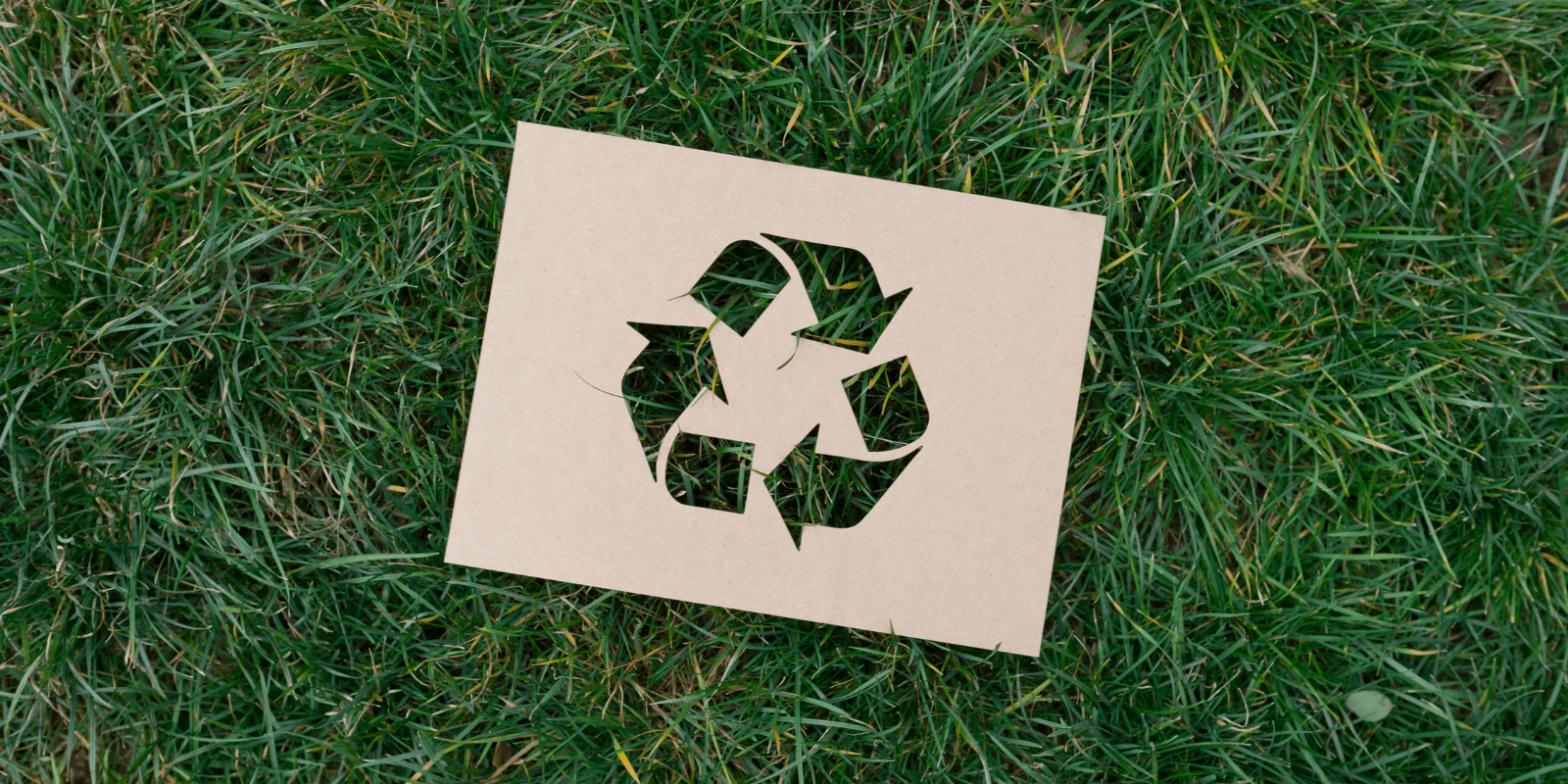 Recycling-Symbol auf grünem Gras als Zeichen für Nachhaltigkeit und Umweltbewusstsein